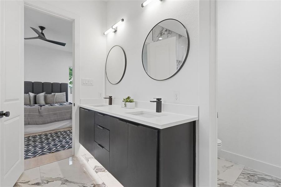 Dual vanity with a white countertop and matte black fixtures Dual vanity with a white countertop and matte black fixtures