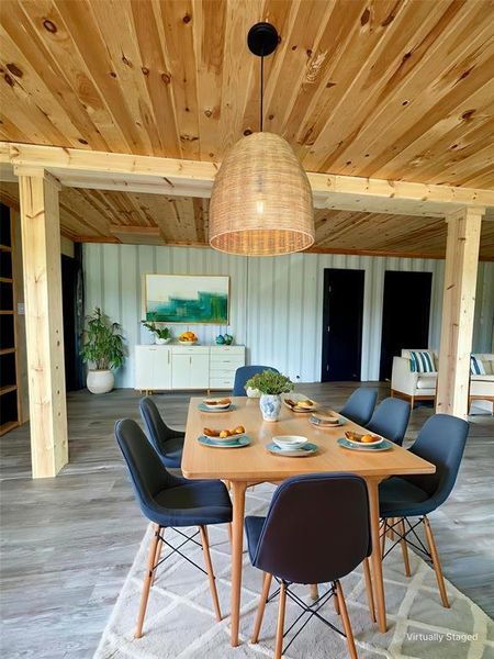 Dining space with wood ceiling and vinyl plank flooring