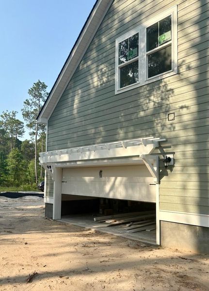 Front exterior of a new home in , Awendaw, SC, highlighting curb appeal (Image 24). Front exterior of a new home in , Awendaw, SC, highlighting curb appeal (Image 24).