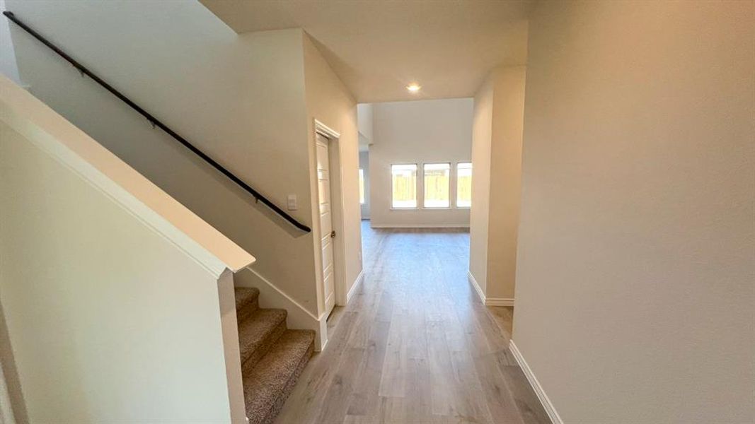 Hall with stairway, light wood-style flooring, and recessed lighting