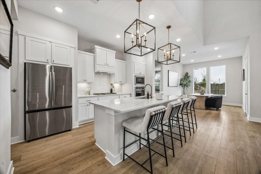 The kitchen flows seamlessly into the dining area, making it easy to cook, gather, and entertain in this open-concept layout.
