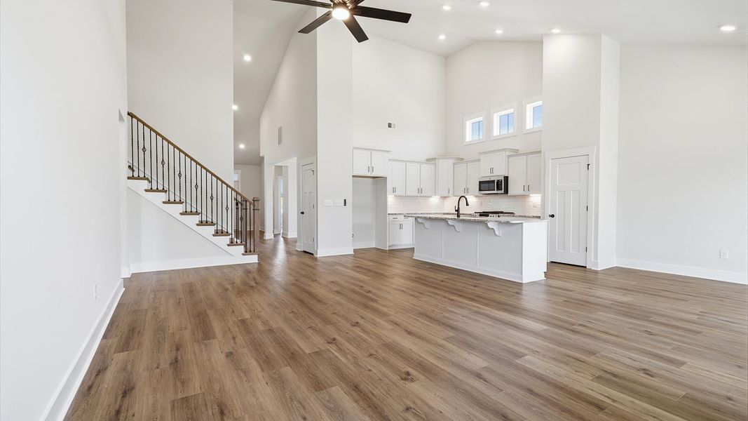 Tasteful family room with two-story volume, refined finishes, and exceptional natural light Tasteful family room with two-story volume, refined finishes, and exceptional natural light