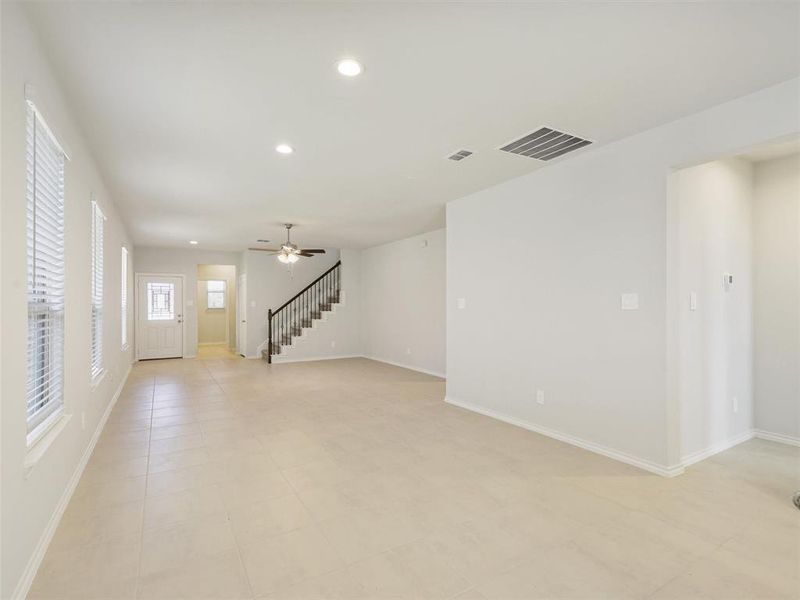 Unfurnished living room featuring visible vents, recessed lighting, baseboards, and stairs Unfurnished living room featuring visible vents, recessed lighting, baseboards, and stairs