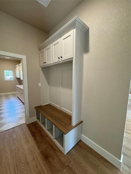 Mudroom featuring baseboards and dark wood-type flooring Mudroom featuring baseboards and dark wood-type flooring