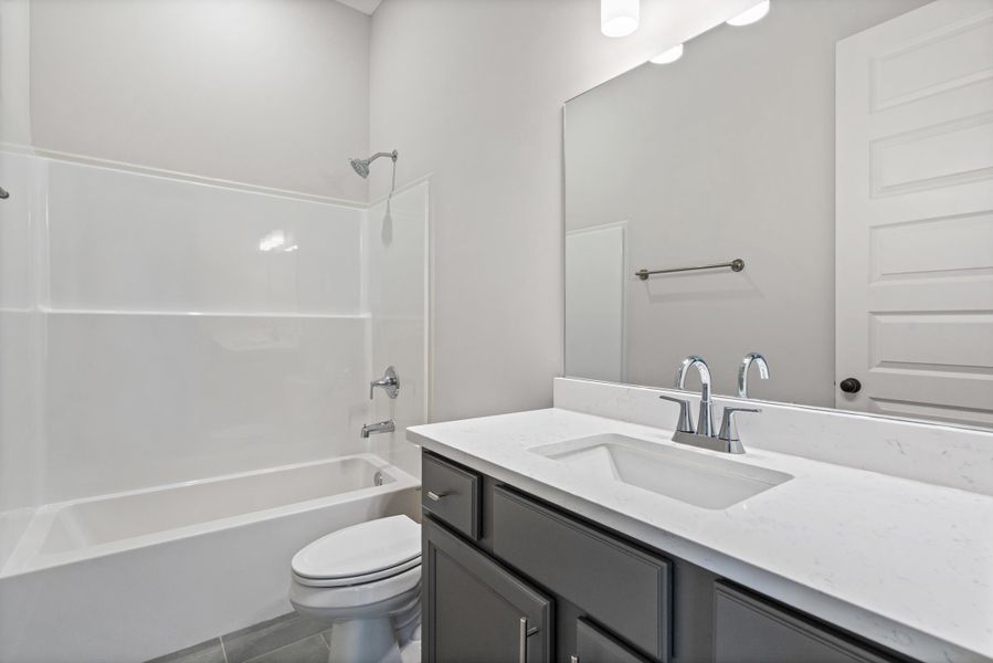 Vanity with white countertop, undermount sink, and chrome faucet