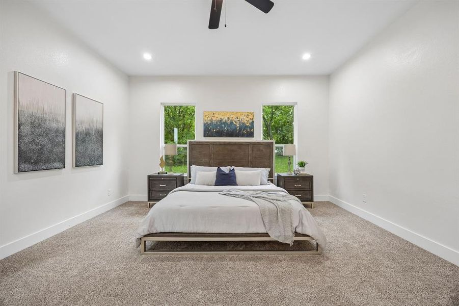 Primary bedroom featuring recessed lighting and a ceiling fan.