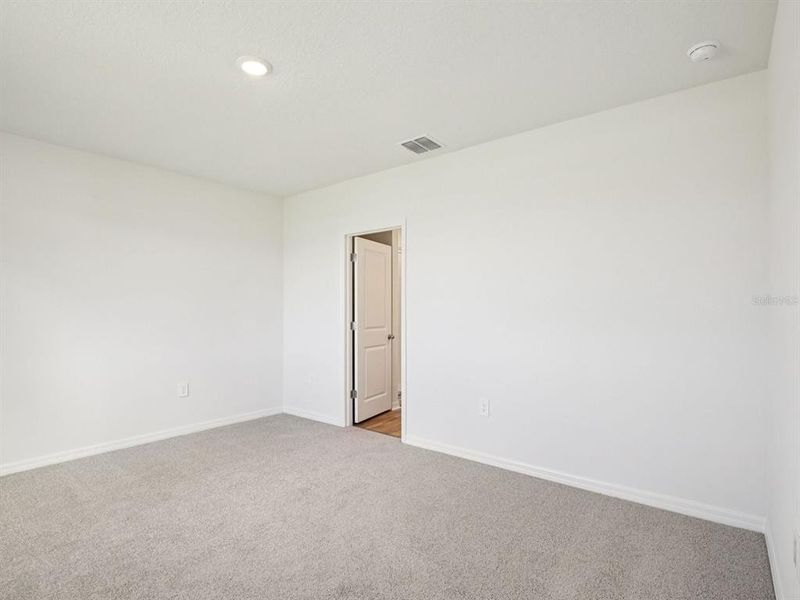 Spacious, unfurnished interior of a new home in The Grove at Stuart Crossing - Premier Series, Bartow (Image 17).