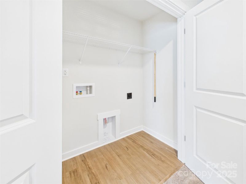 Laundry area is conveniently located off Primary Suite with linen closet in hallway next to.