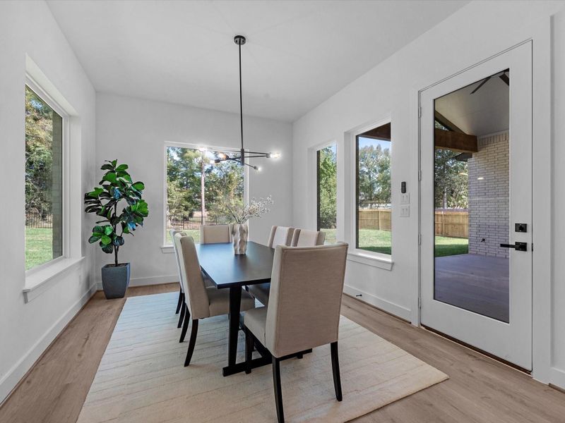 Adjacent dining area with serene backyard views