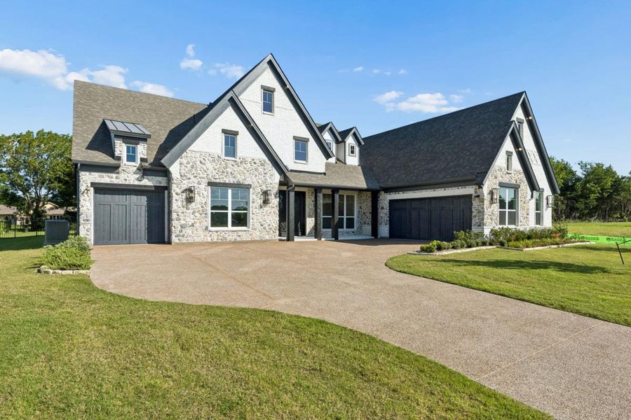 Front exterior of a new home in Heath Golf & Yacht Club, Heath, TX, highlighting curb appeal (Image 2). Front exterior of a new home in Heath Golf & Yacht Club, Heath, TX, highlighting curb appeal (Image 2).