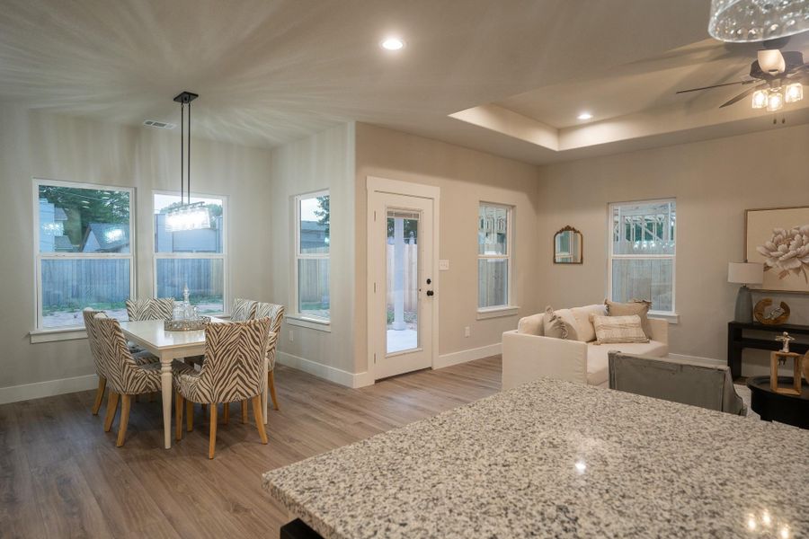 Dining space with light wood-style floors, baseboards, plenty of natural light, ceiling fan, and recessed lighting