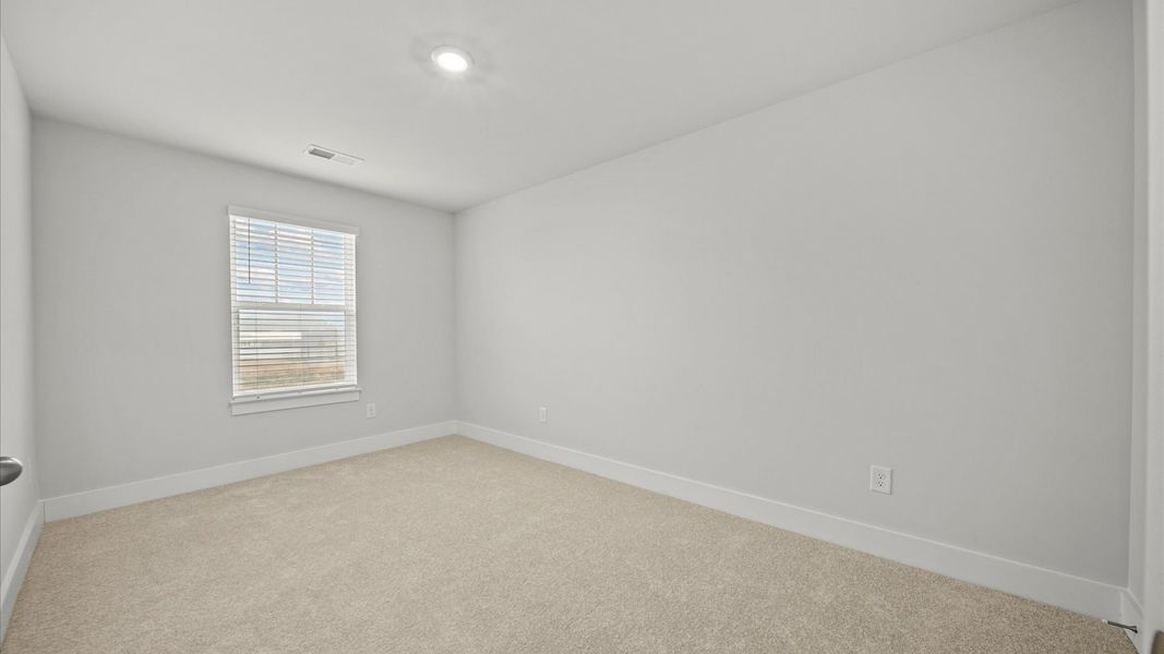 First-class bedroom with generous proportions, a walk-in closet, and beautiful natural light through large windows