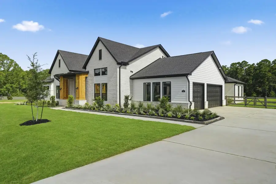 Front exterior of a new home in Bentwood Farms, Montgomery, TX, highlighting curb appeal (Image 2).