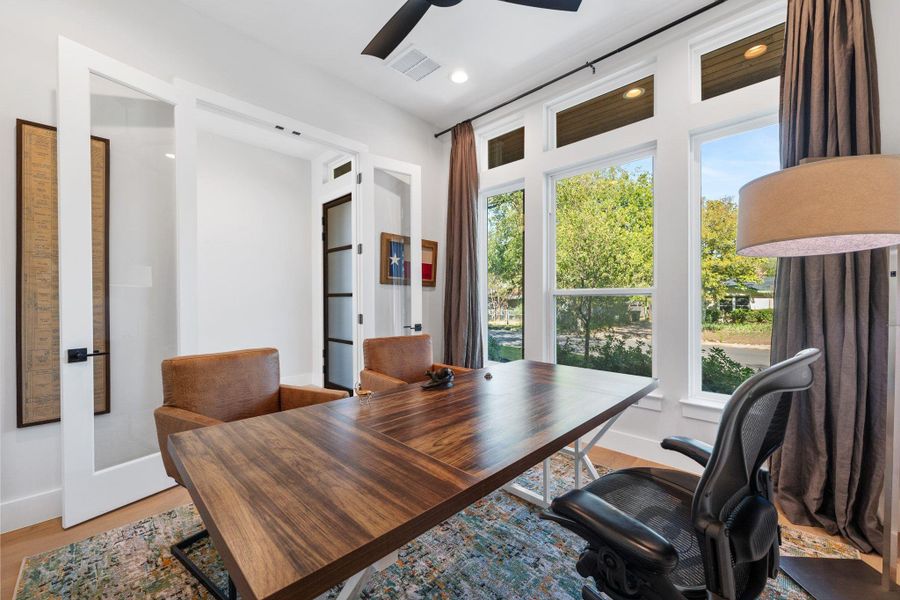 Office space featuring light wood-type flooring and recessed lighting