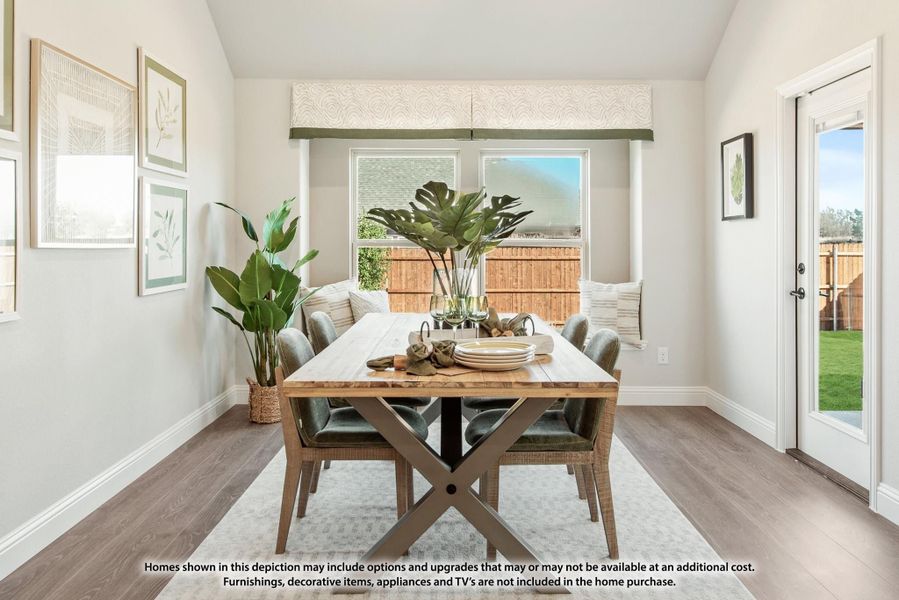 Dining room with wood table, upholstered chairs, hardwood floors, and glass door leading to backyard Dining room with wood table, upholstered chairs, hardwood floors, and glass door leading to backyard