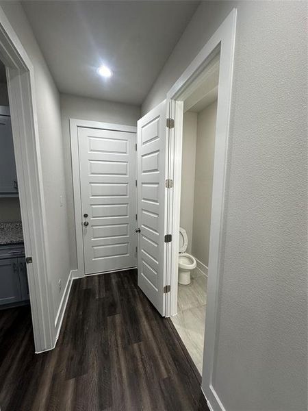 Corridor with dark hardwood / wood-style flooring