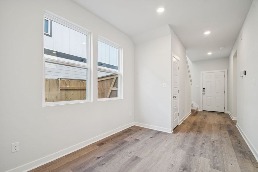 A room with white walls and a wood floor.
