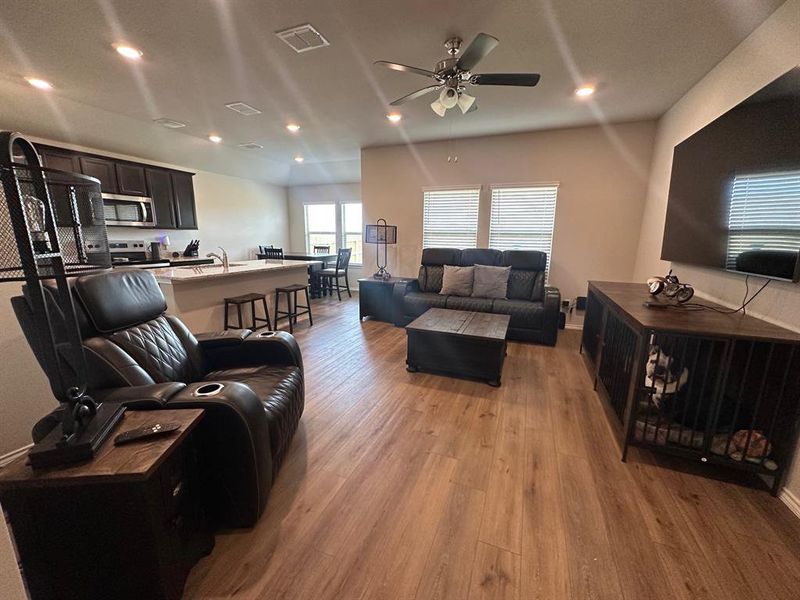 Living room with recessed lighting, light wood finished floors, and ceiling fan
