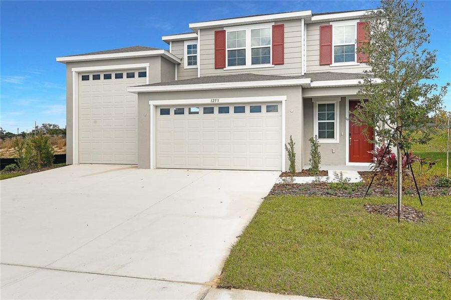Front exterior of a new home in Seasons at Bella Vista, Dundee, FL, highlighting curb appeal (Image 2). Front exterior of a new home in Seasons at Bella Vista, Dundee, FL, highlighting curb appeal (Image 2).