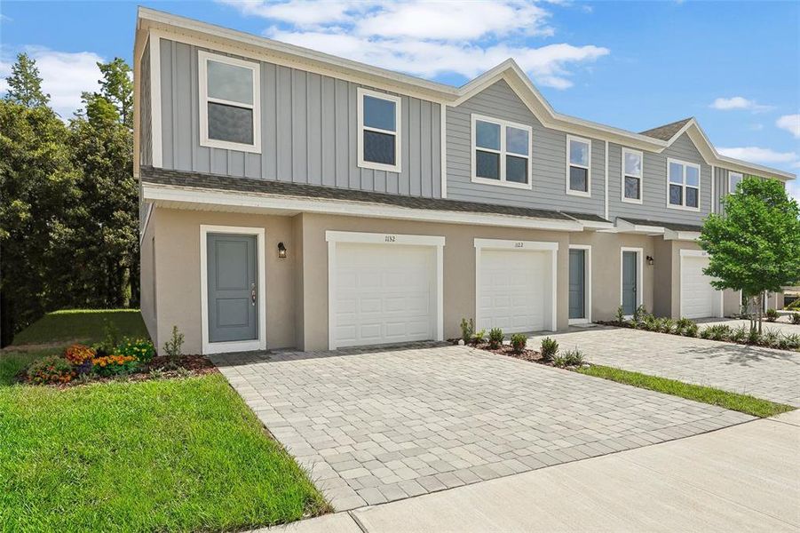 Front exterior of a new home in Bimini Bay, Davenport, FL, highlighting curb appeal (Image 1). Front exterior of a new home in Bimini Bay, Davenport, FL, highlighting curb appeal (Image 1).
