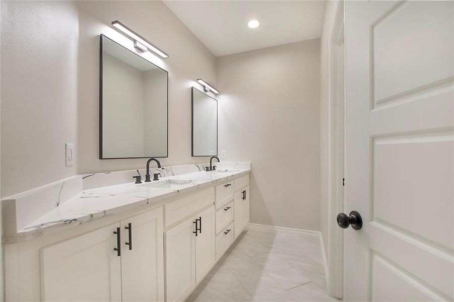 Full bath featuring double vanity, light tile patterned floors, and recessed lighting Full bath featuring double vanity, light tile patterned floors, and recessed lighting
