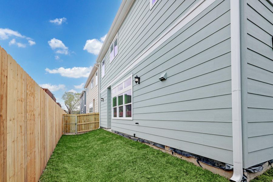 Private fenced backyard with lush green lawn, ideal for relaxation and outdoor activities. Private fenced backyard with lush green lawn, ideal for relaxation and outdoor activities.