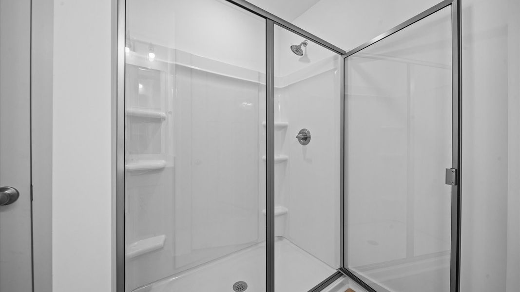 Exceptional en-suite with dual vanity and glass-enclosed walk-in shower for superior everyday comfort Exceptional en-suite with dual vanity and glass-enclosed walk-in shower for superior everyday comfort