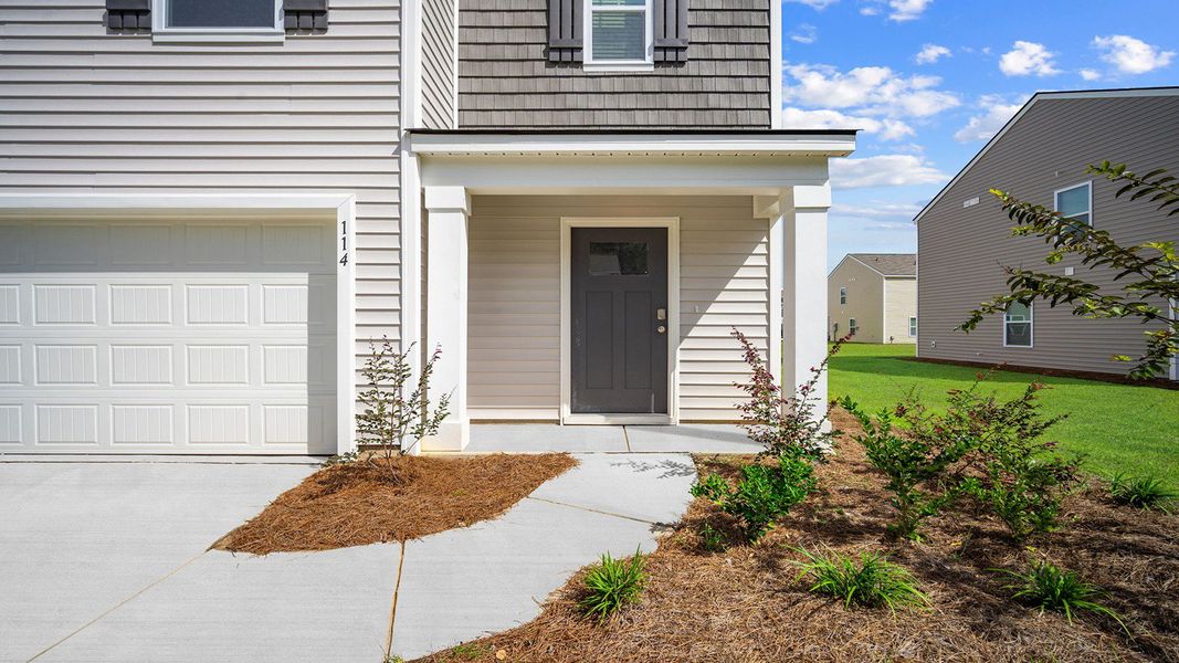Exterior details and patio area of a home in Cobblestone Village, Savannah (Image 3).