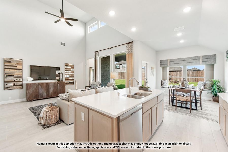 Open-concept kitchen with island sink flowing into living and dining areas, high vaulted ceiling and ceiling fan