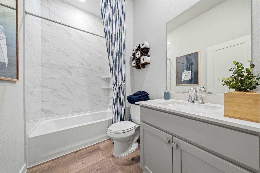 A bathroom with a tub toilet and sink. A bathroom with a tub toilet and sink.