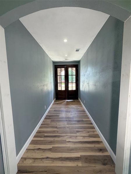 Arched entryway leading to French doors