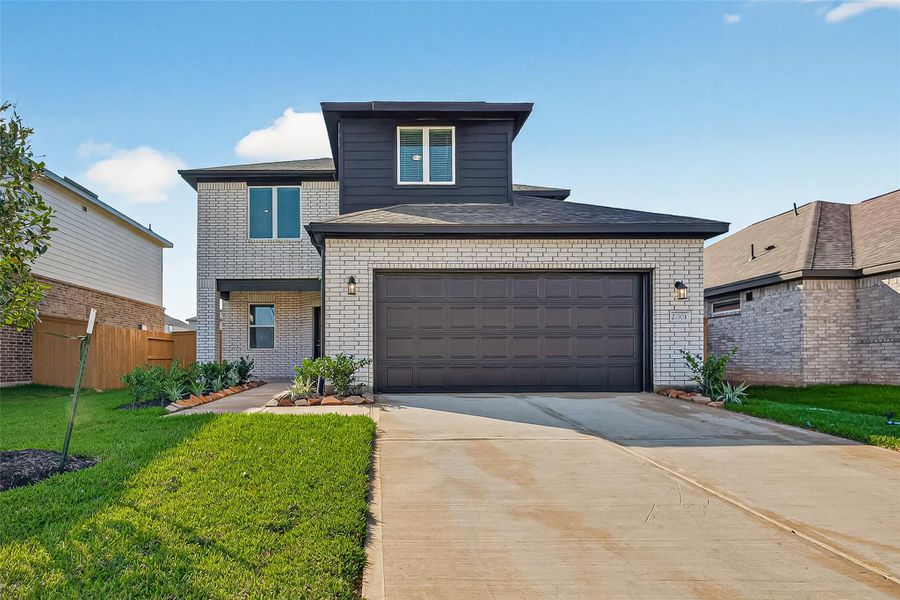 Front exterior of a new home in Sunterra, Katy, TX, highlighting curb appeal (Image 1). Front exterior of a new home in Sunterra, Katy, TX, highlighting curb appeal (Image 1).