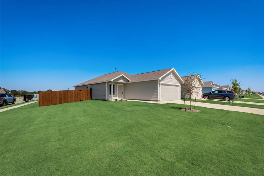 View of home's exterior with concrete driveway and an attached garage View of home's exterior with concrete driveway and an attached garage