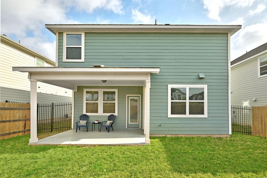 Rear view of property featuring a fenced backyard and a patio