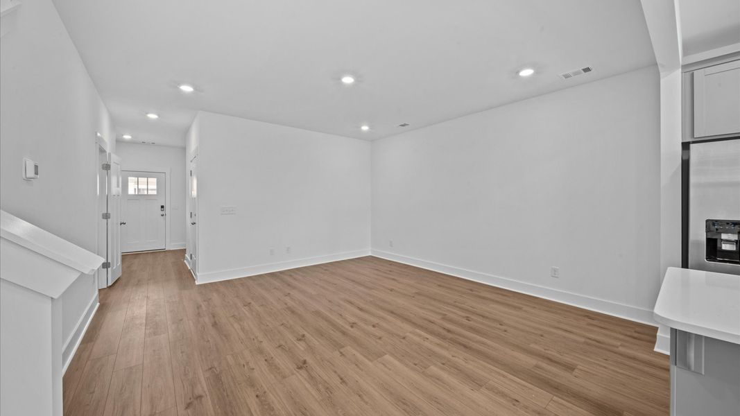Open concept, hardwood flooring family room in two story townhome at Ransdell Pointe by DRB Homes in Spartanburg, SC
