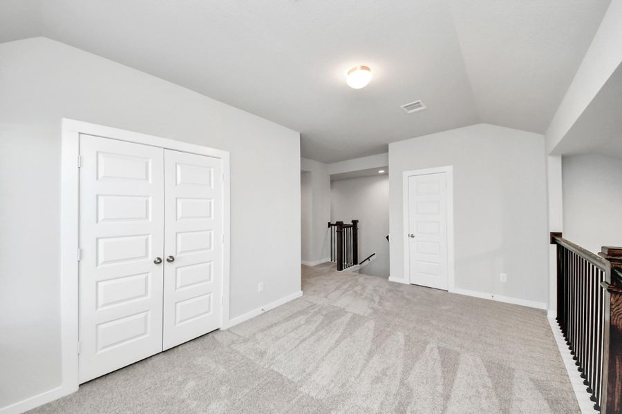 Come upstairs and enjoy a day of leisure in this fabulous game room! This is the perfect hangout spot or adult game room! Features plush carpet, high ceilings, custom paint and windows for plenty of natural light. Sample photo of completed home with similar floor plan. Actual colors and selections may vary.