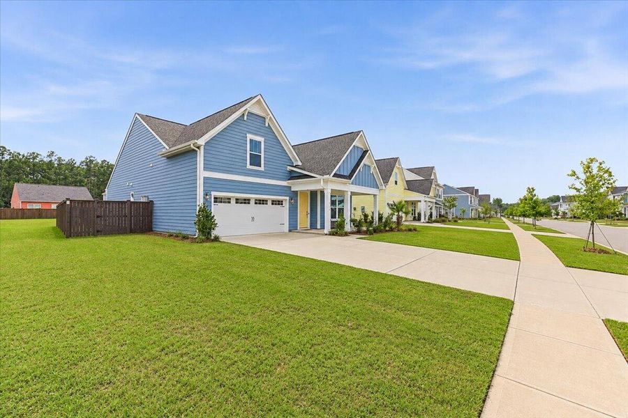Front exterior of a new home in Homecoming, Ravenel, SC, highlighting curb appeal (Image 28). Front exterior of a new home in Homecoming, Ravenel, SC, highlighting curb appeal (Image 28).