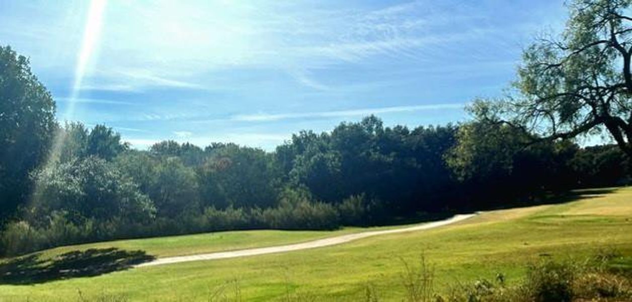 View of community with golf course view and a yard View of community with golf course view and a yard