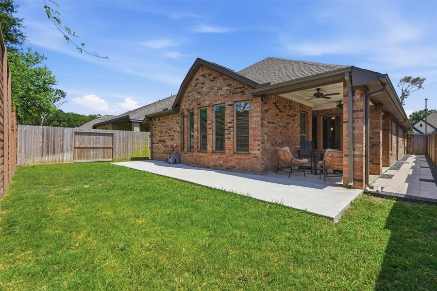 Enjoy outdoor living in the fully fenced backyard featuring an extended covered patio with ceiling fans—perfect for relaxing or entertaining. The home's four-sided brick exterior offers timeless curb appeal and low-maintenance durability. Enjoy outdoor living in the fully fenced backyard featuring an extended covered patio with ceiling fans—perfect for relaxing or entertaining. The home's four-sided brick exterior offers timeless curb appeal and low-maintenance durability.