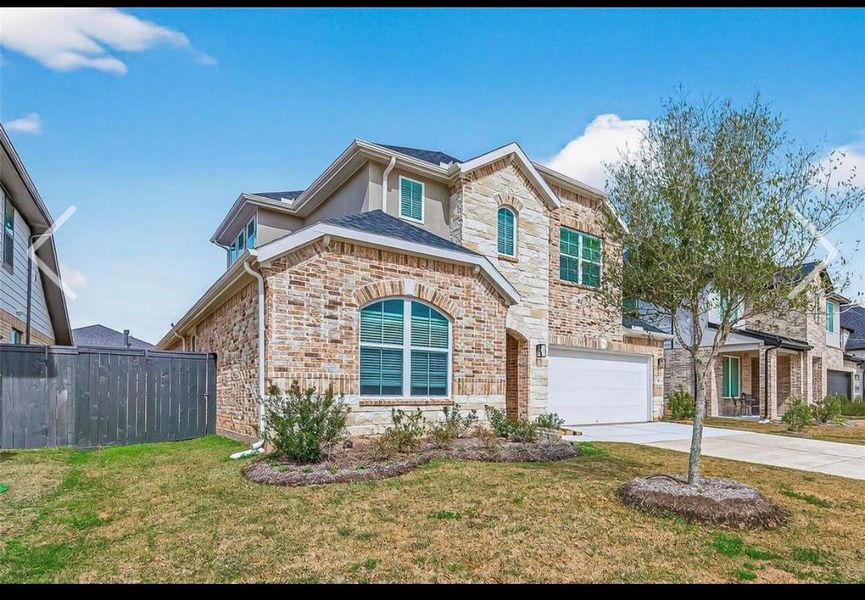 Front exterior of a new home in Harvest Green, Richmond, TX, highlighting curb appeal (Image 22).