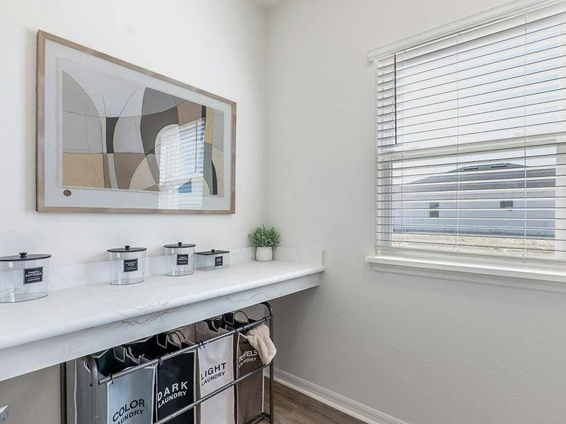 A counter in the laundry room is perfect for sorting and folding - Monroe by Highland Homes