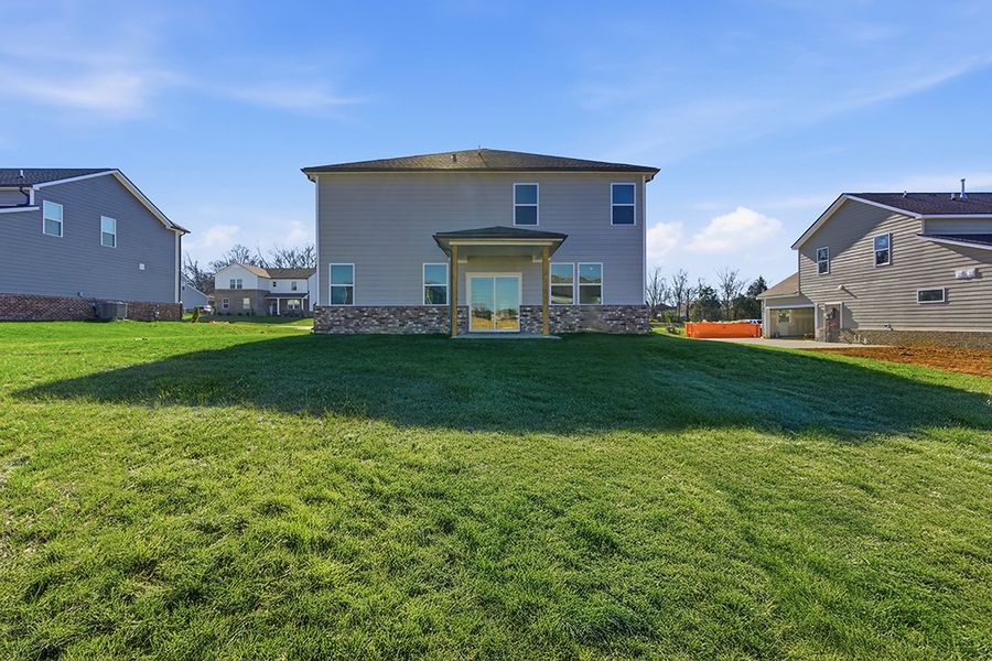 A grassy area with buildings in the background.