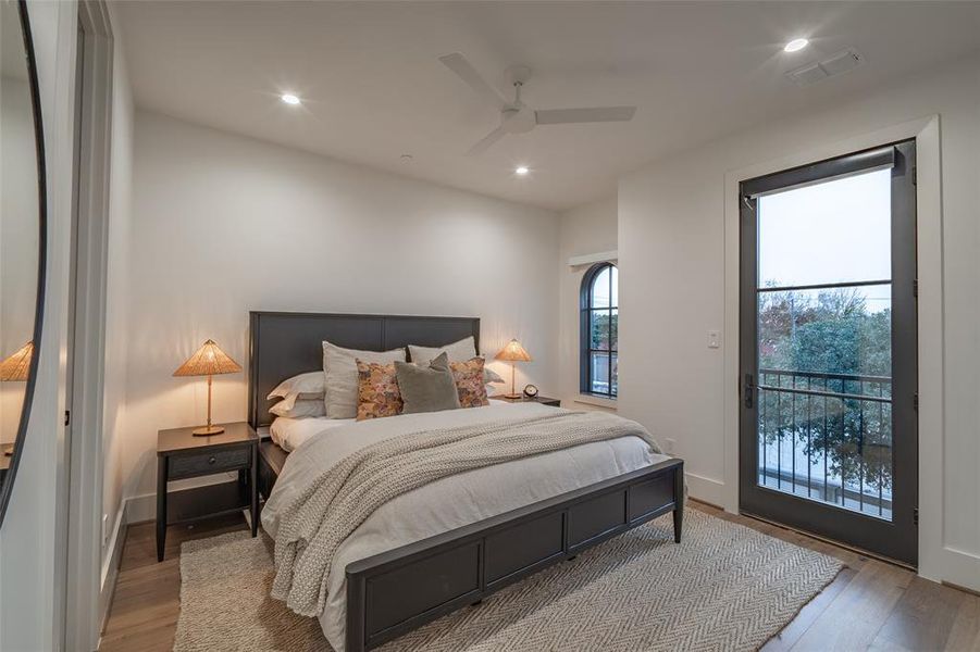 Bedroom with access to exterior, light hardwood / wood-style flooring, and ceiling fan