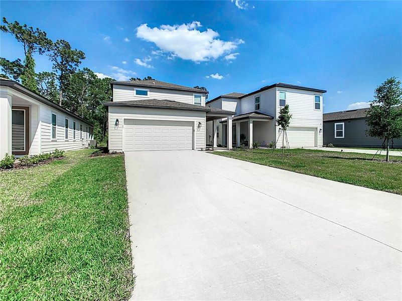 Front exterior of a new home in , Winter Garden, FL, highlighting curb appeal (Image 23).
