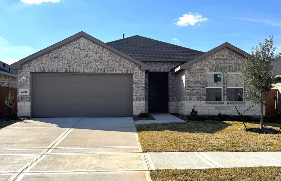 Front exterior of a new home in Sunterra, Katy, TX, highlighting curb appeal (Image 1). Front exterior of a new home in Sunterra, Katy, TX, highlighting curb appeal (Image 1).
