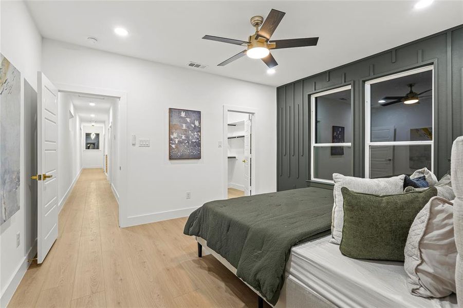 Bedroom with light wood-style flooring, recessed lighting, ceiling fan, and a spacious closet