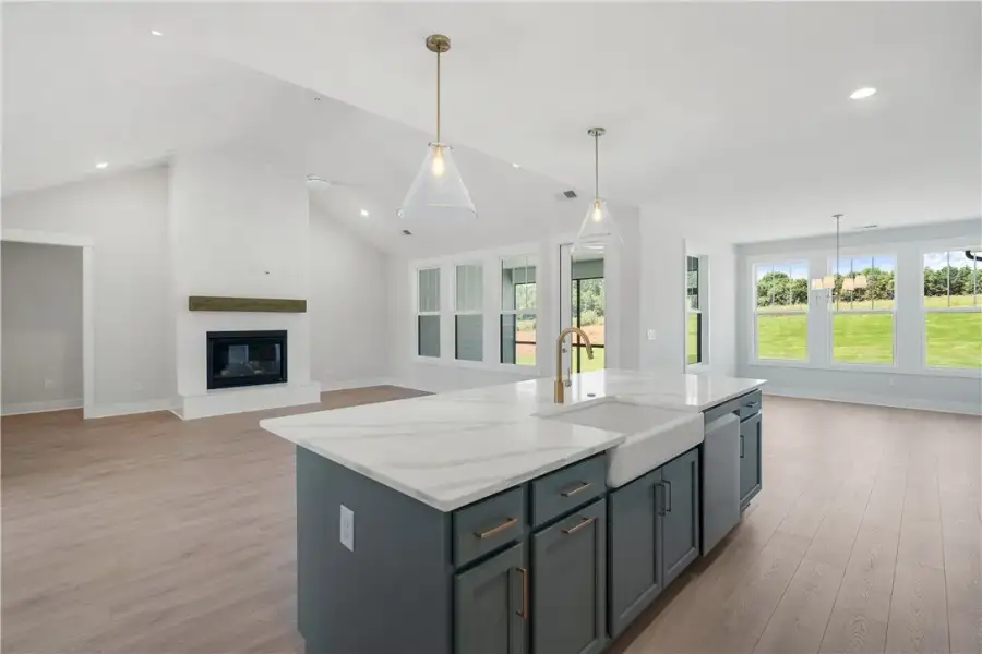 A grand living space featuring vaulted ceilings, a A grand living space featuring vaulted ceilings, a