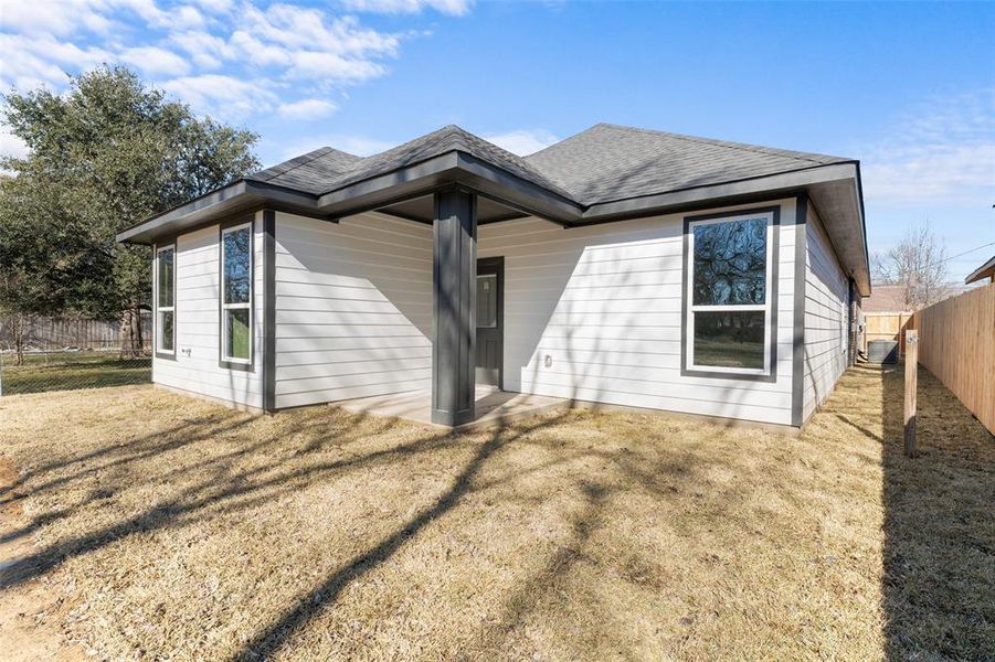 Rear view of property featuring a yard