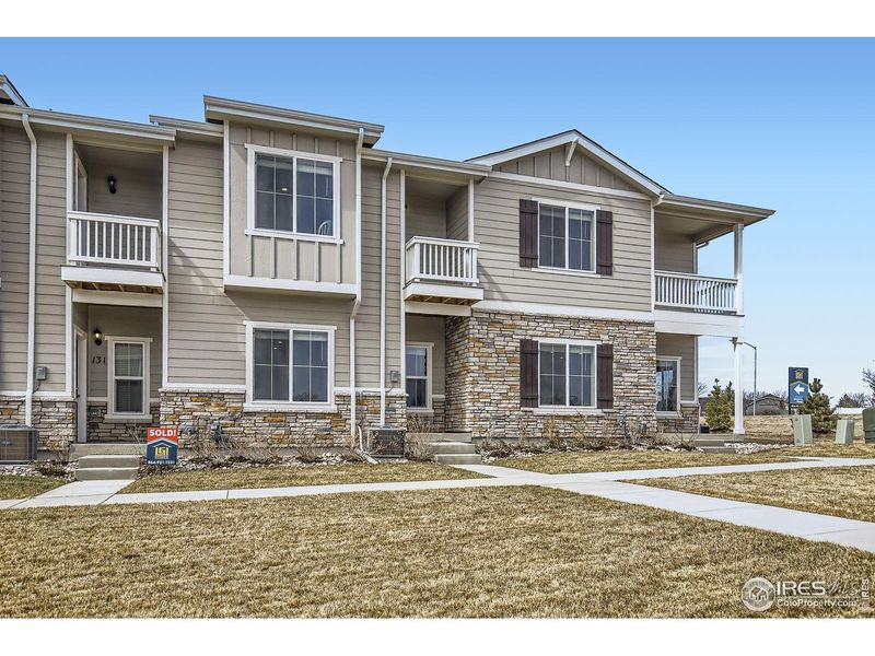 Front exterior of a new home in Johnstown Village, Johnstown, CO, highlighting curb appeal (Image 2). Front exterior of a new home in Johnstown Village, Johnstown, CO, highlighting curb appeal (Image 2).