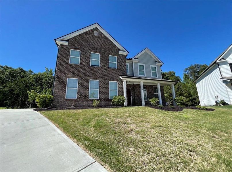 Front exterior of a new home in Autumn Brook, Austell, GA, highlighting curb appeal (Image 1). Front exterior of a new home in Autumn Brook, Austell, GA, highlighting curb appeal (Image 1).